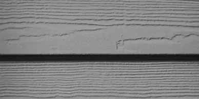Gray wood siding with horizontal lines.