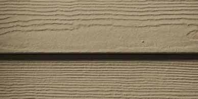 Close-up of light brown siding with textured horizontal lines and a dark shadow line.