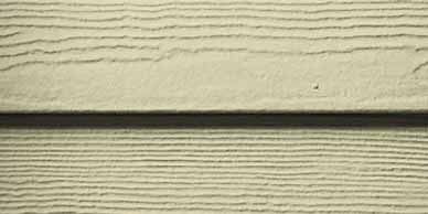 Beige siding with horizontal wood grain texture.