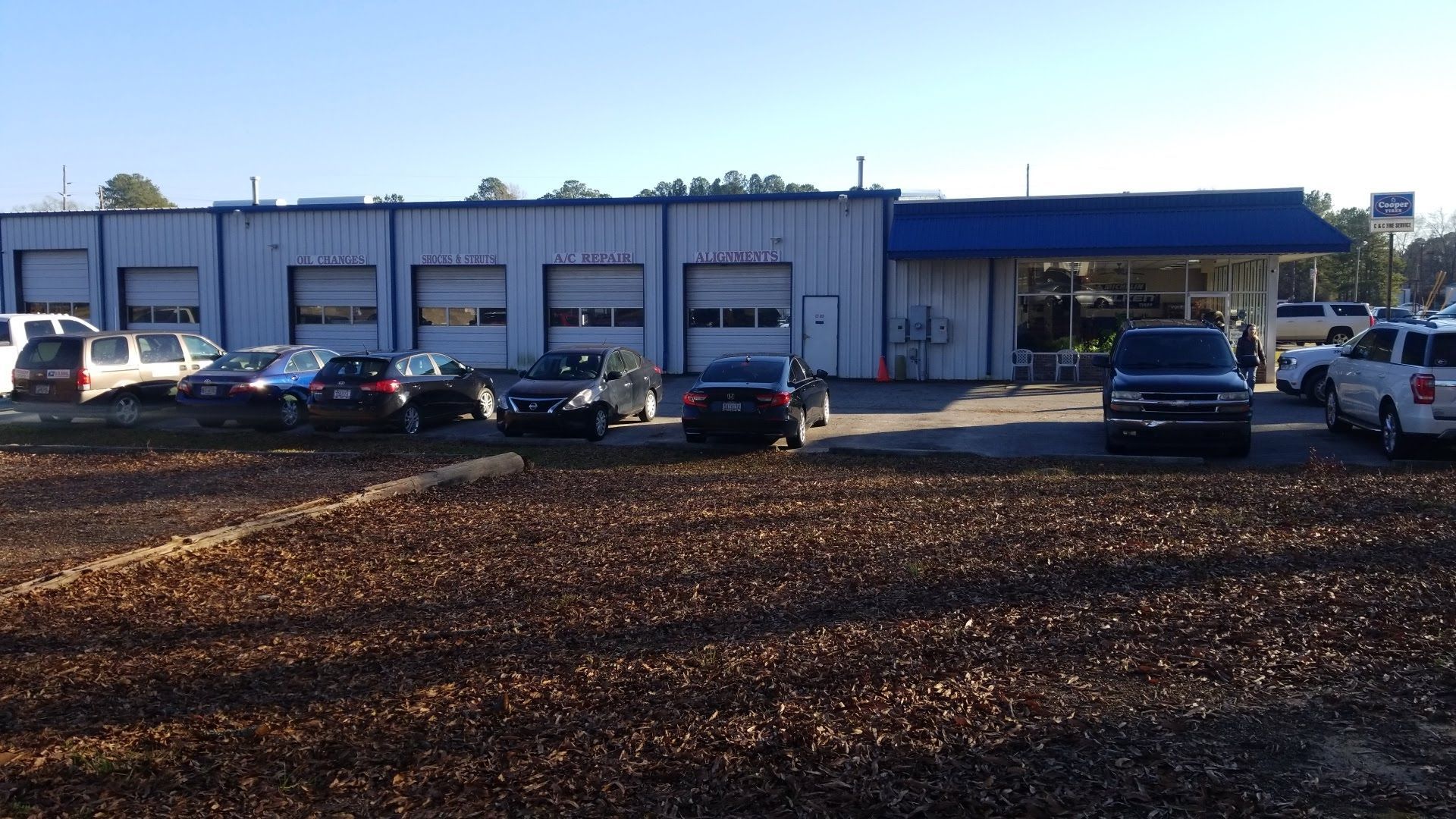 Wide Exterior View Of C And C Tire Service Shop And Parking Area | C&C Tire Service
