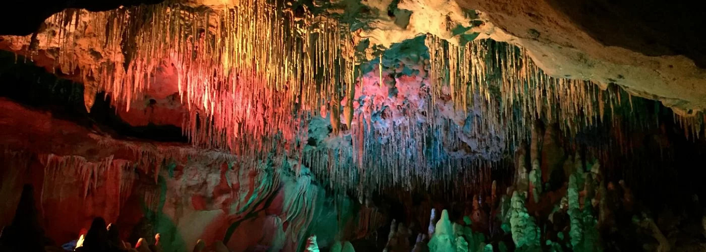 A cave with a lot of colorful lights hanging from the ceiling.