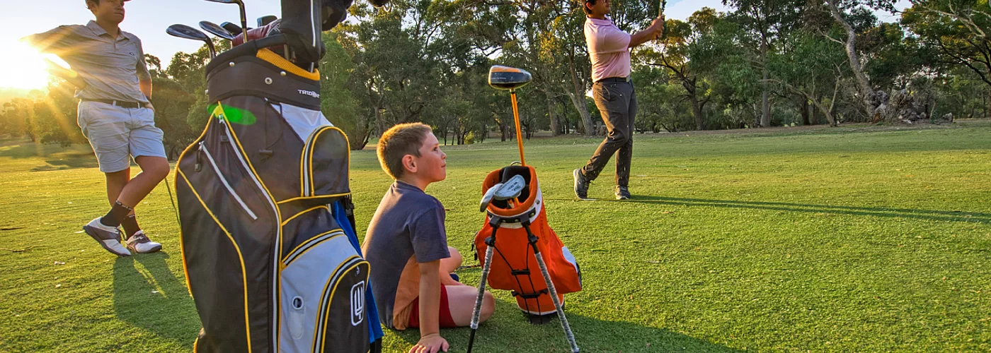 A group of people are playing golf on a golf course.