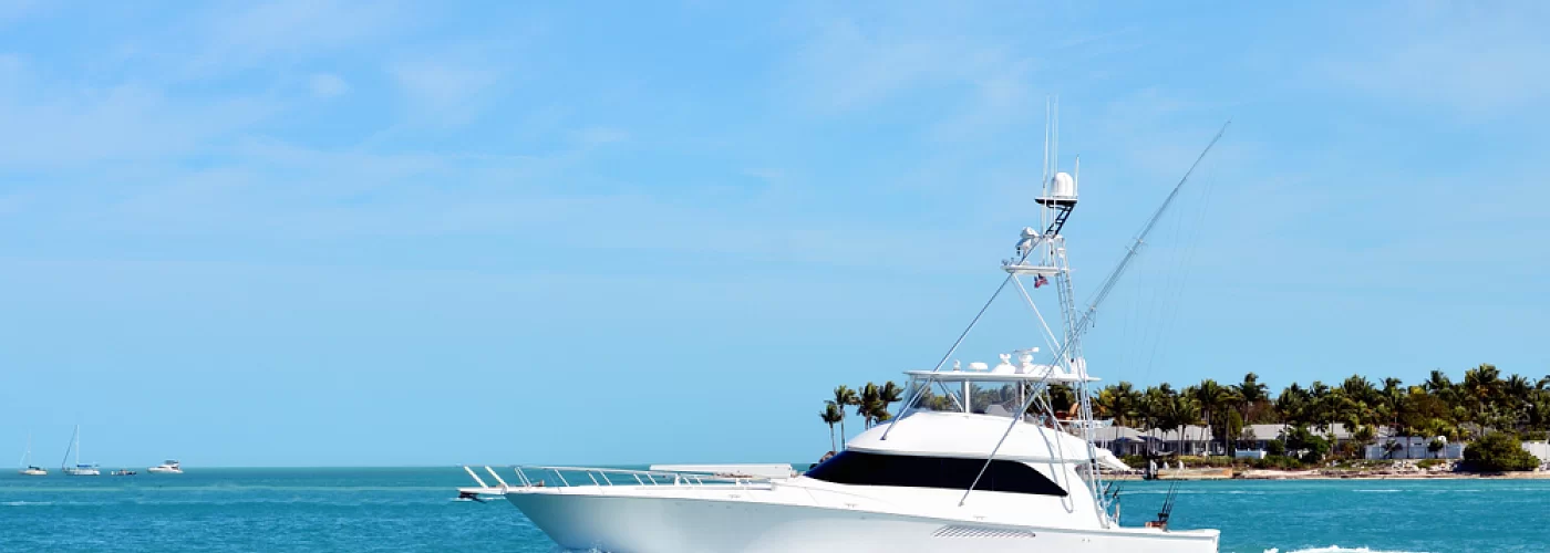 A white boat is floating on top of a body of water.