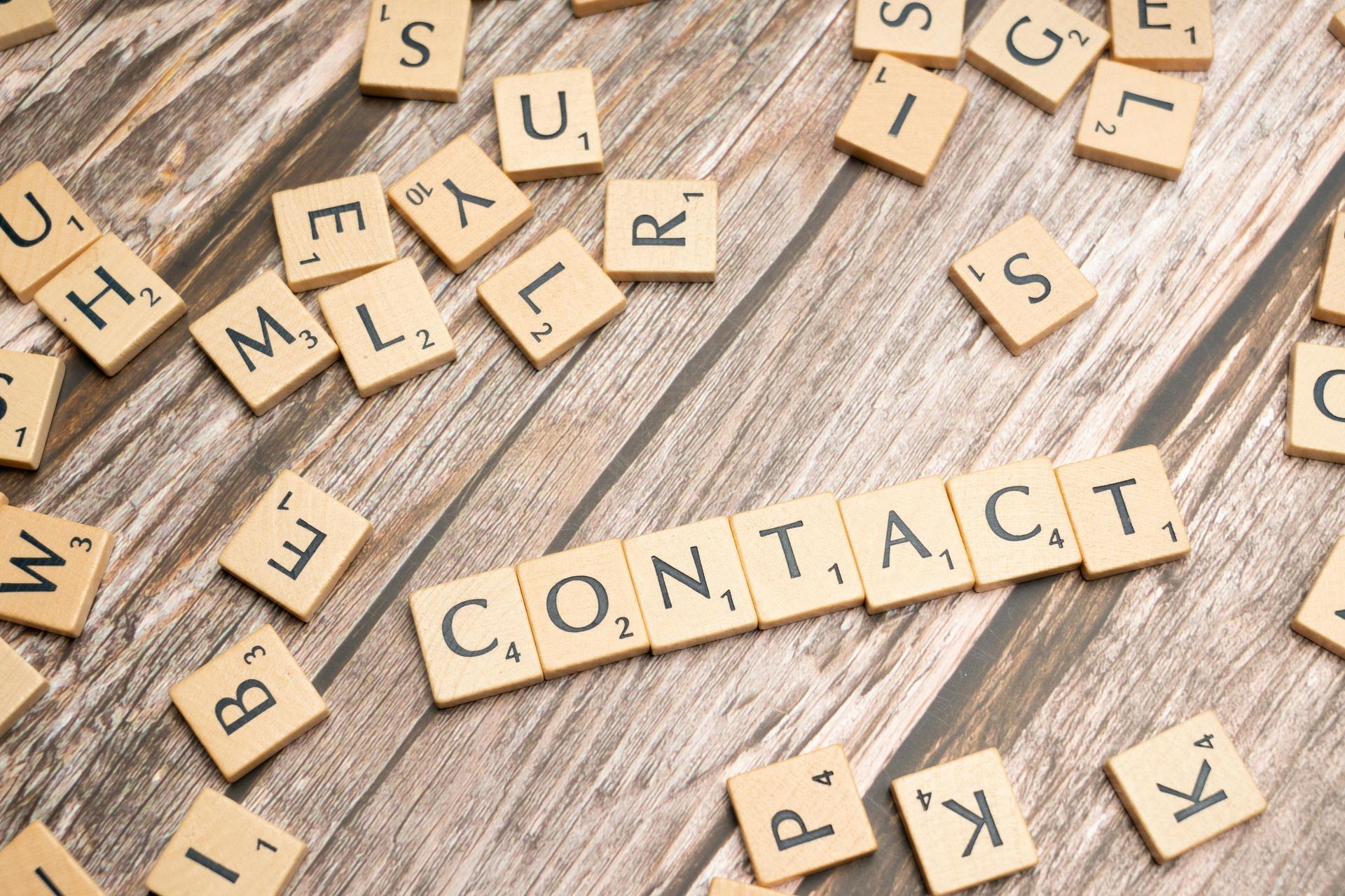 Contact spelt out in scrabble pieces