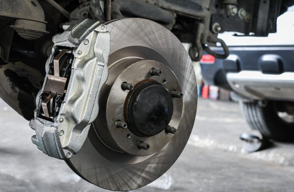 A Close Up of a Brake Disc on a Car — Fosters Ace Auto Repairs In Aitkenvale, QLD
