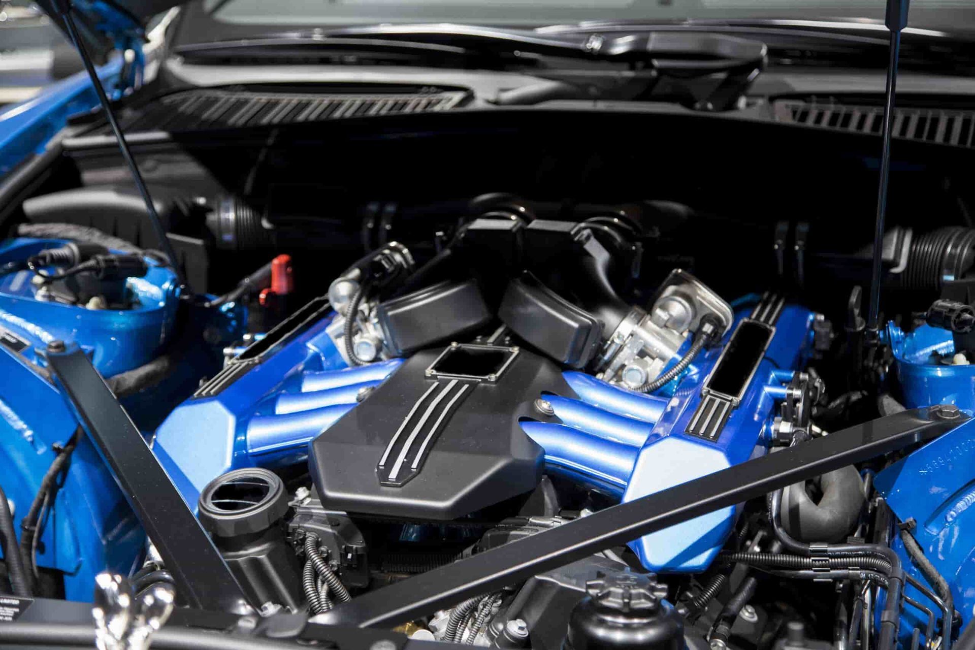 The Engine of a Blue Sports Car With the Hood Open — Fosters Ace Auto Repairs In Aitkenvale, QLD
