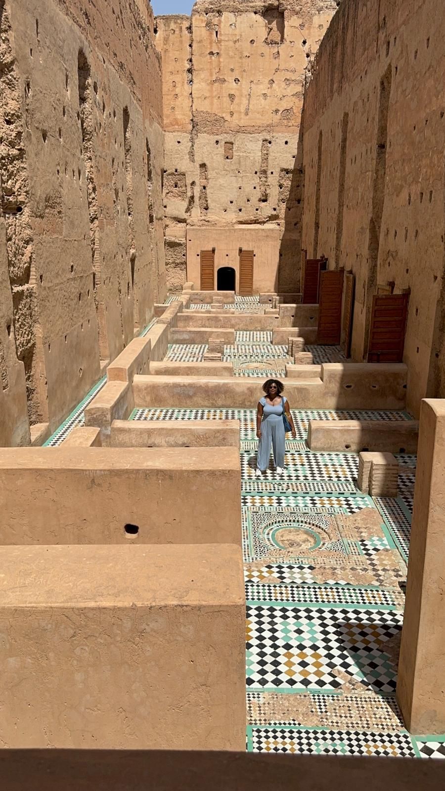 A person is walking up a set of stairs in an old building.