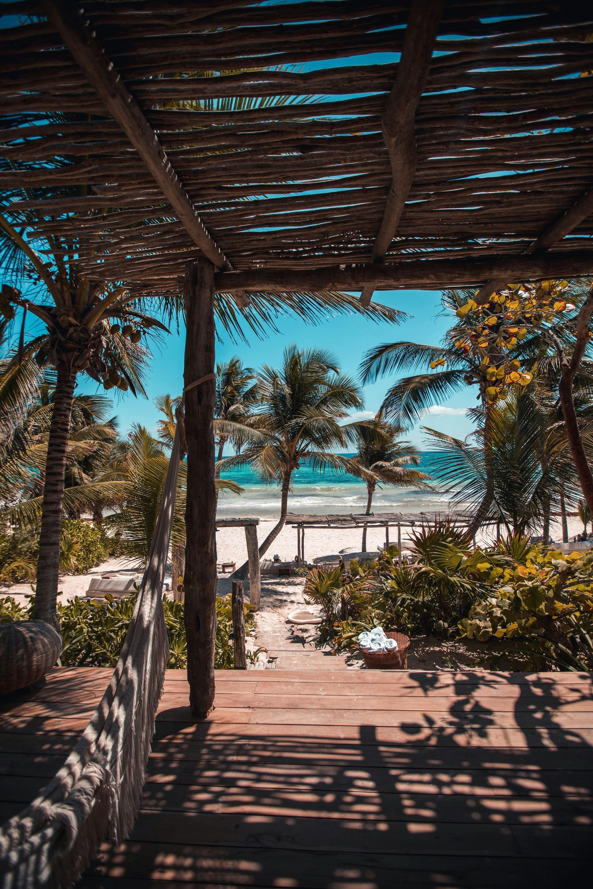 A beach with a lot of people and buildings in the background.