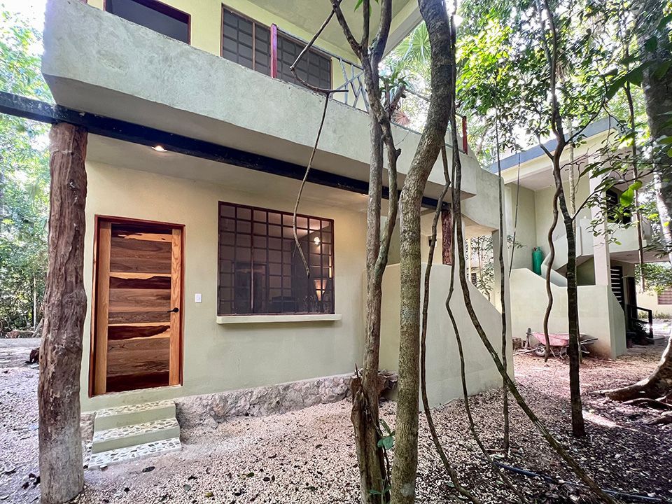 A hotel room surrounded by jungle.