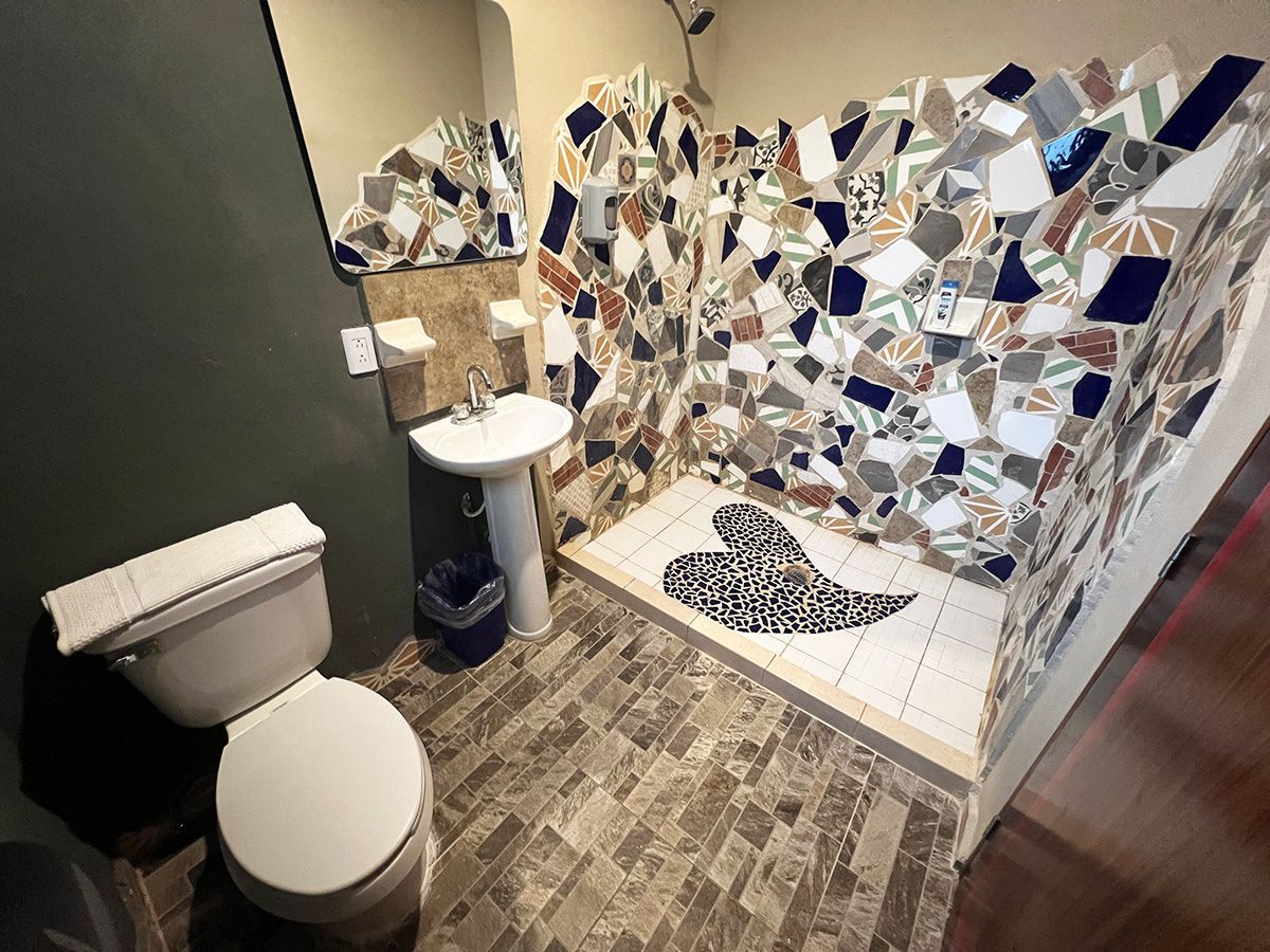A bathroom with a toilet , sink , and shower.
