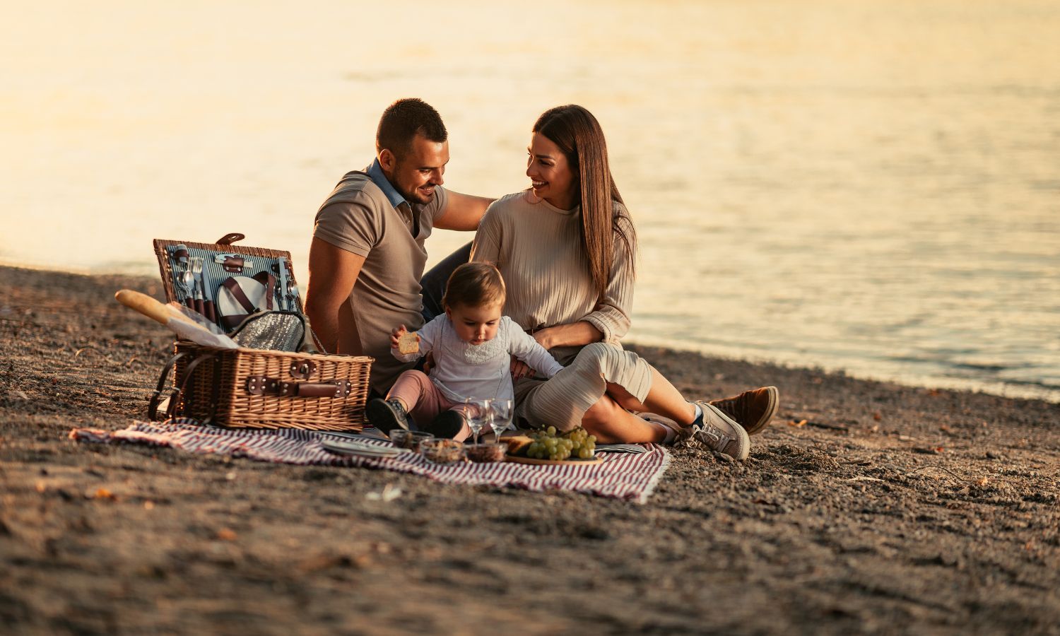 Family enjoying a beach picnic at Carolina Beach during a soft sunny day.