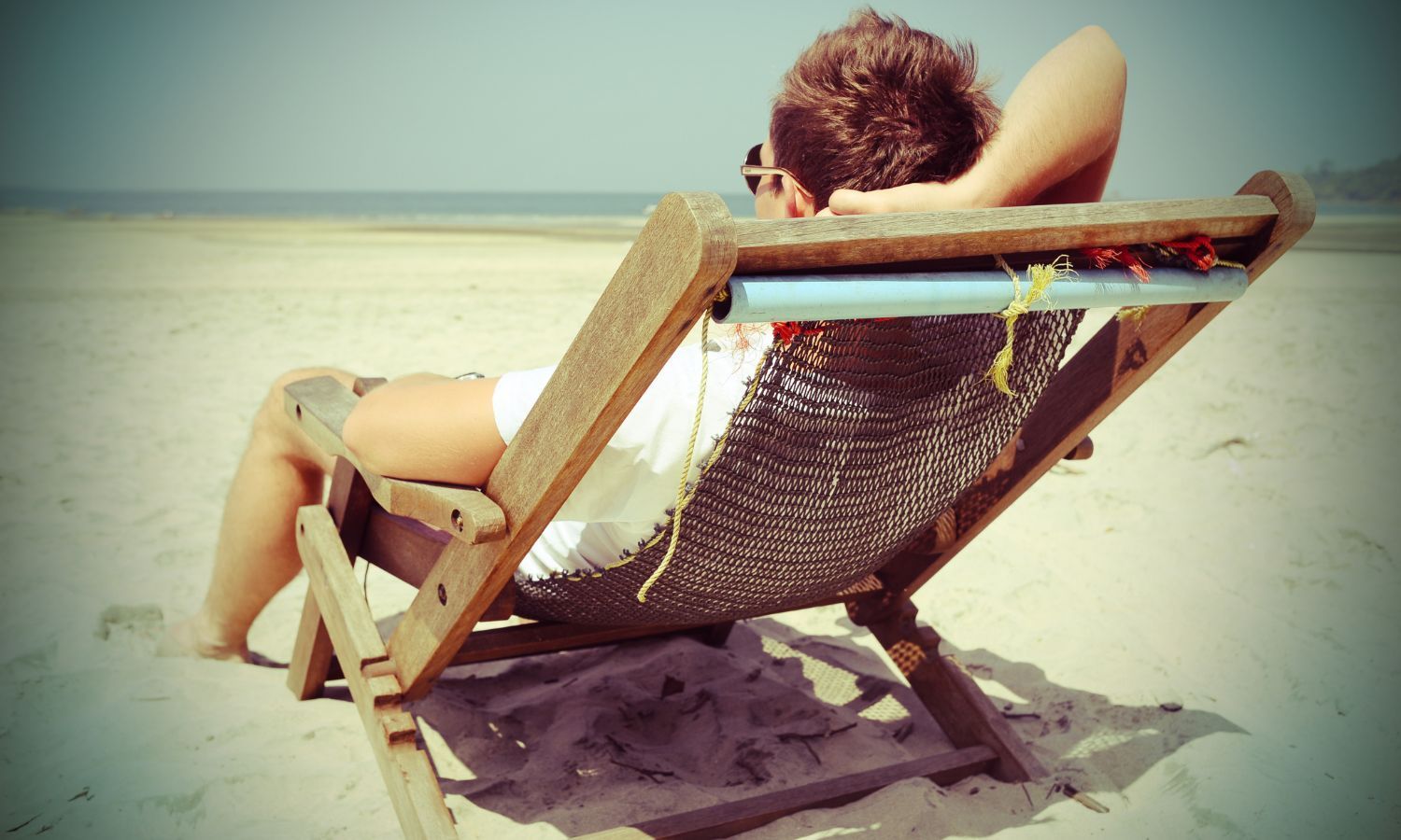 man relaxing in chair on Carolina Beach