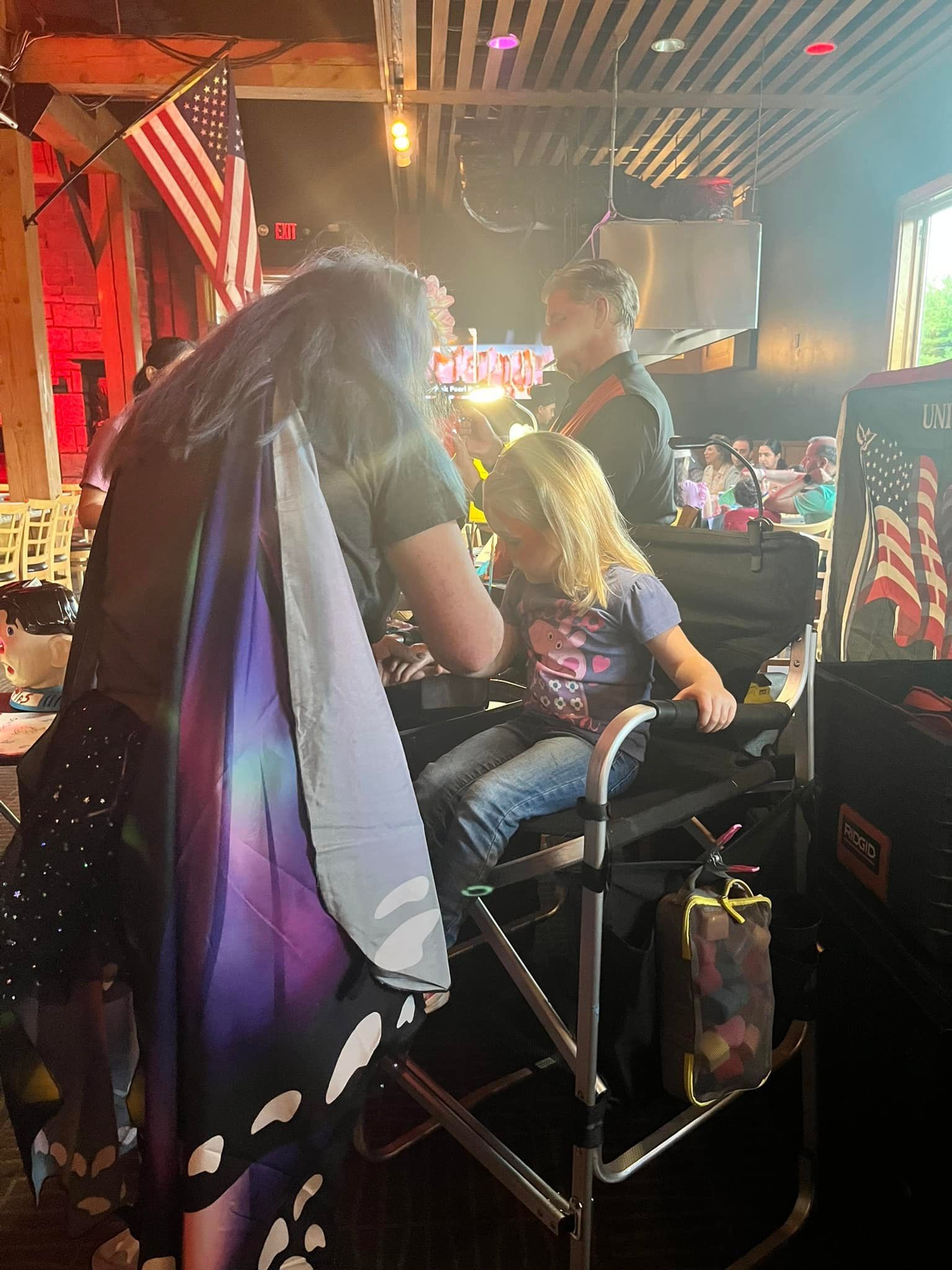 A little girl getting her face painted at desaki