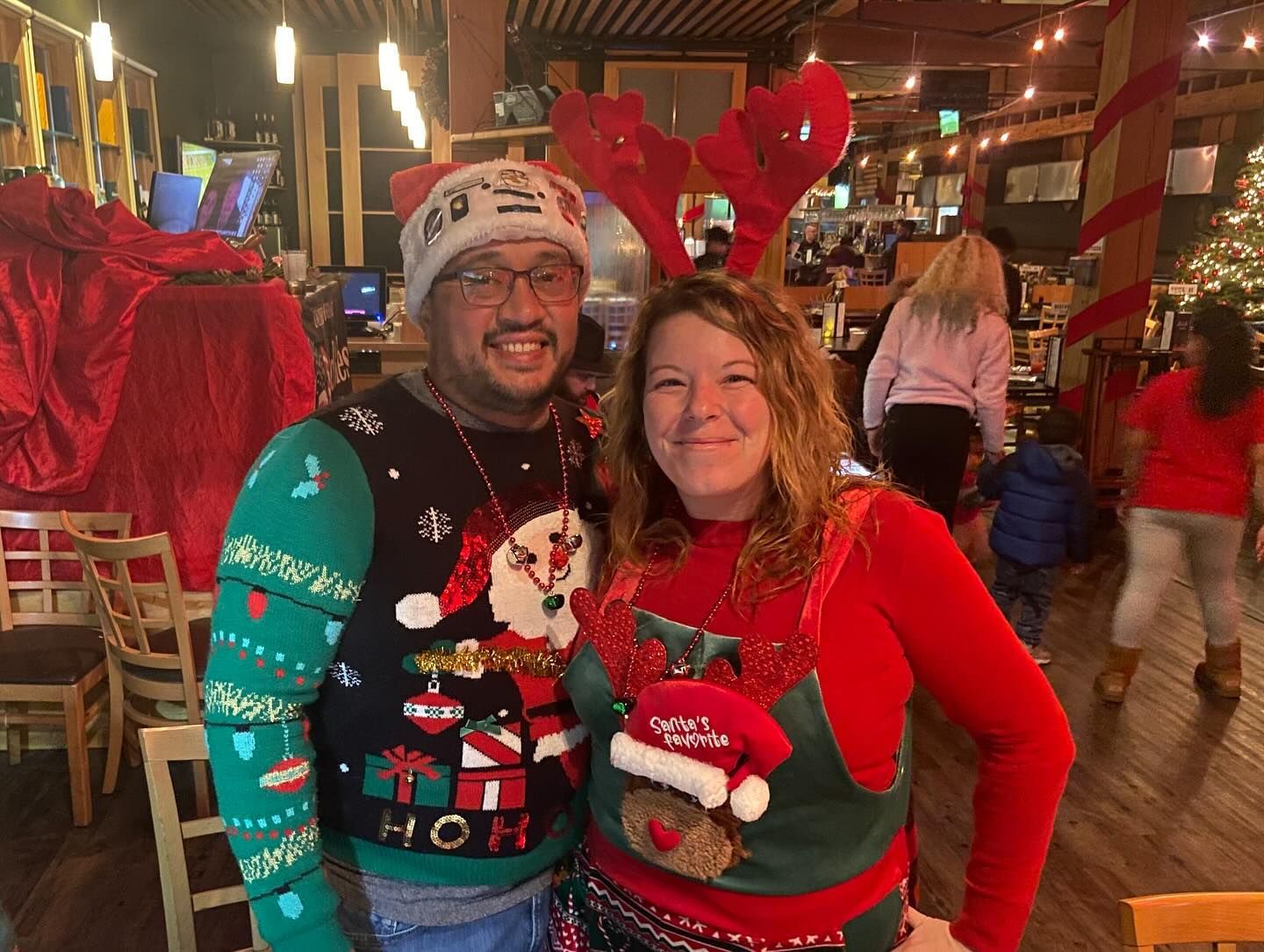 Couple in ugly christmas sweaters