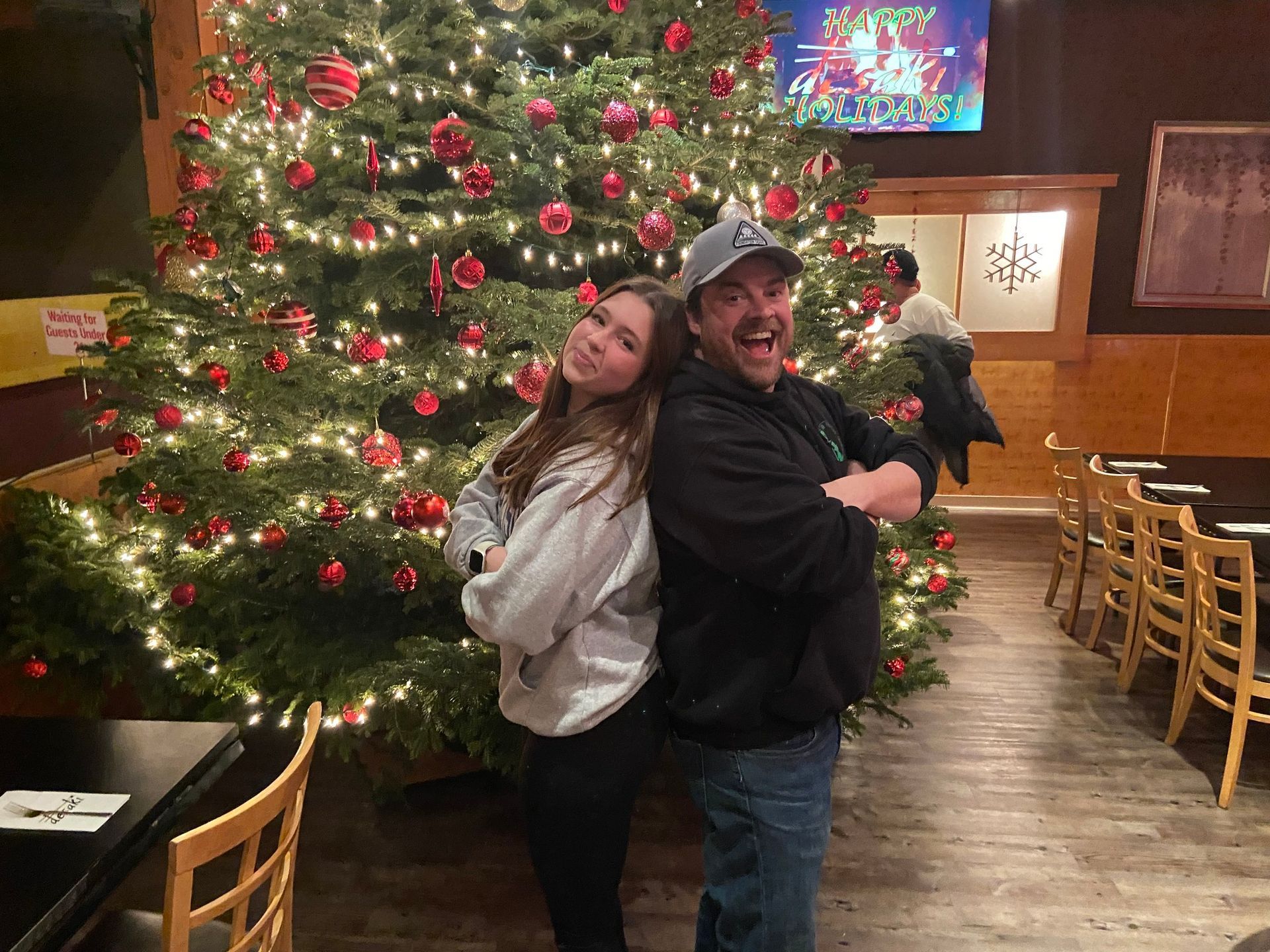 A daughter with her father by the christmas tree at desaki