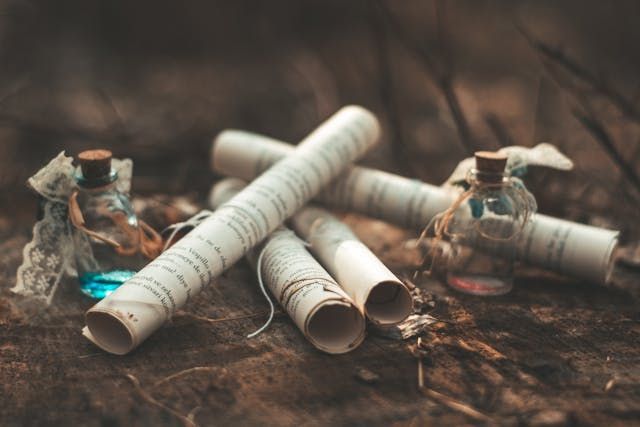 Rolled papers and small glass bottles create a thoughtful scene for direct cremation Bernalillo, NM