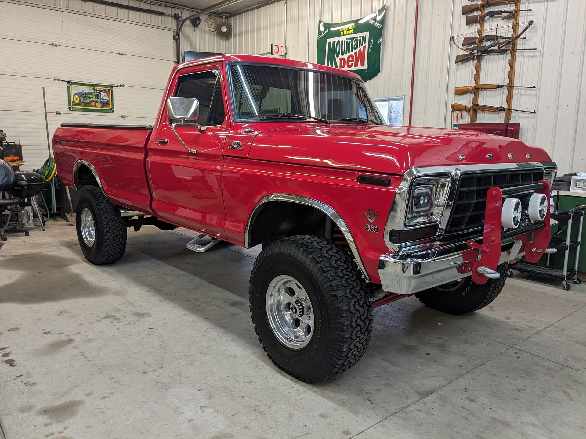 A red pickup truck is parked in a garage.