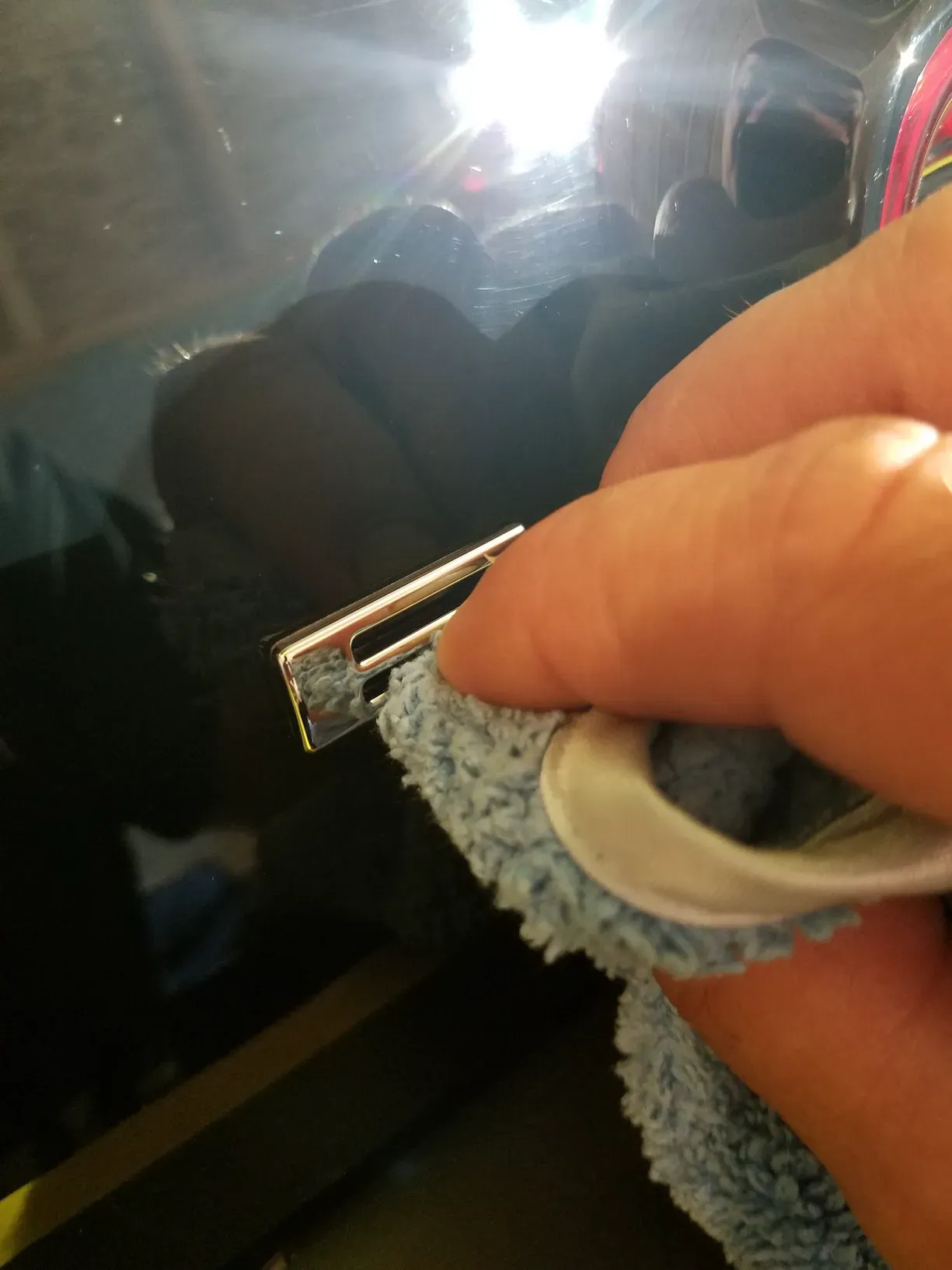 A close up of a person cleaning a key with a cloth