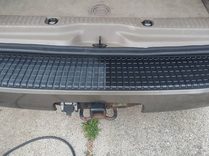 The rear bumper of a car is being cleaned