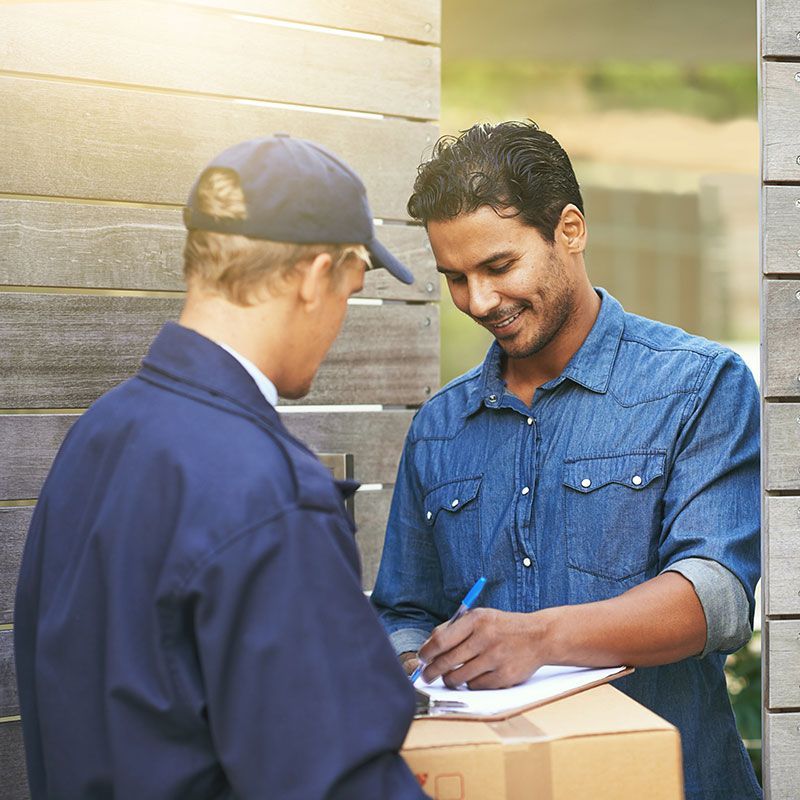 A smiling man receiving a same-day delivered package