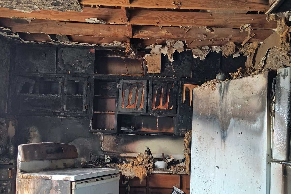  Fire‑damaged kitchen showing the aftermath of a house fire