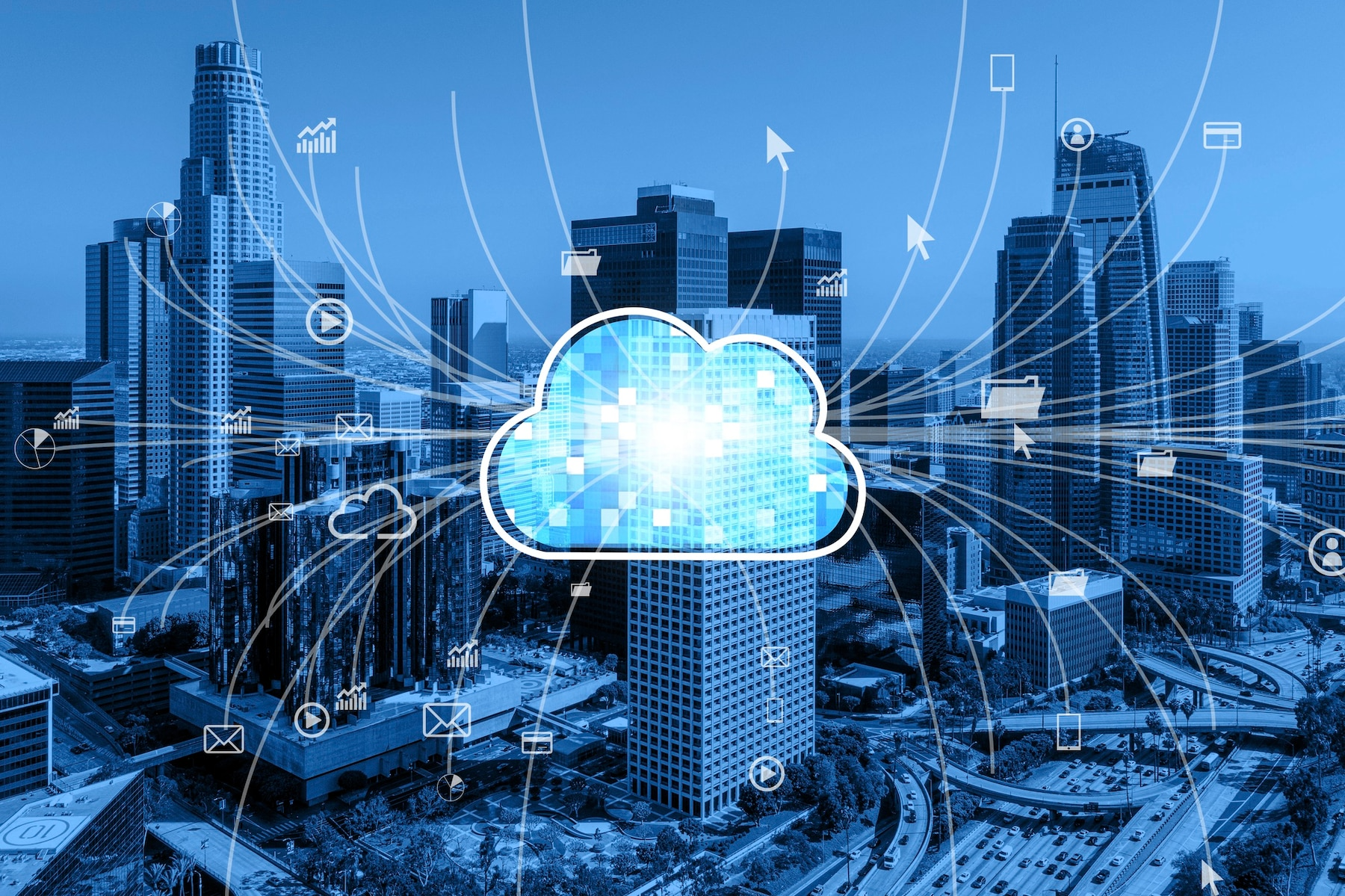 Blue cityscape with a digital cloud, data flowing between cloud and buildings.