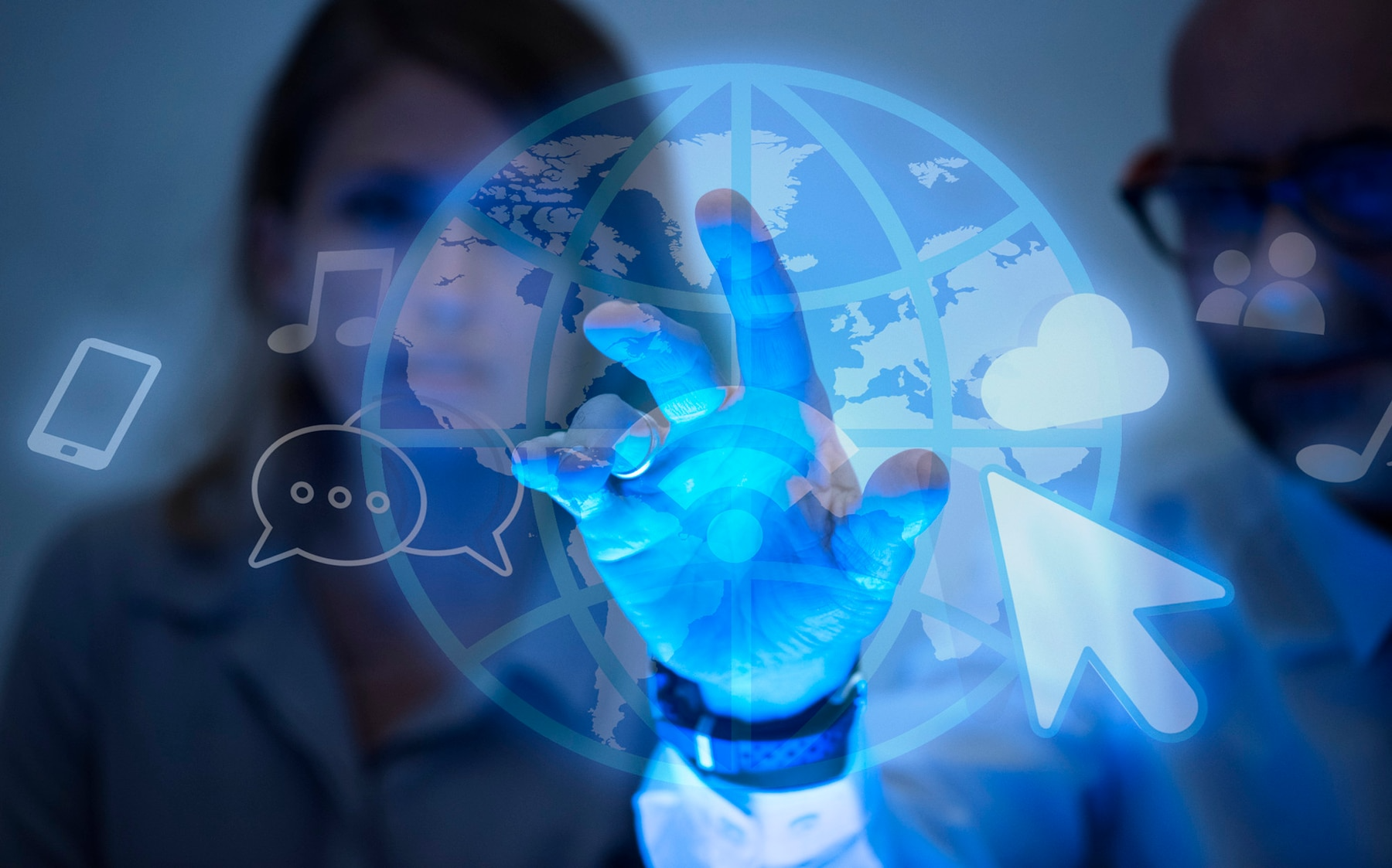 Person touching glowing globe with tech icons, representing global technology and communication.