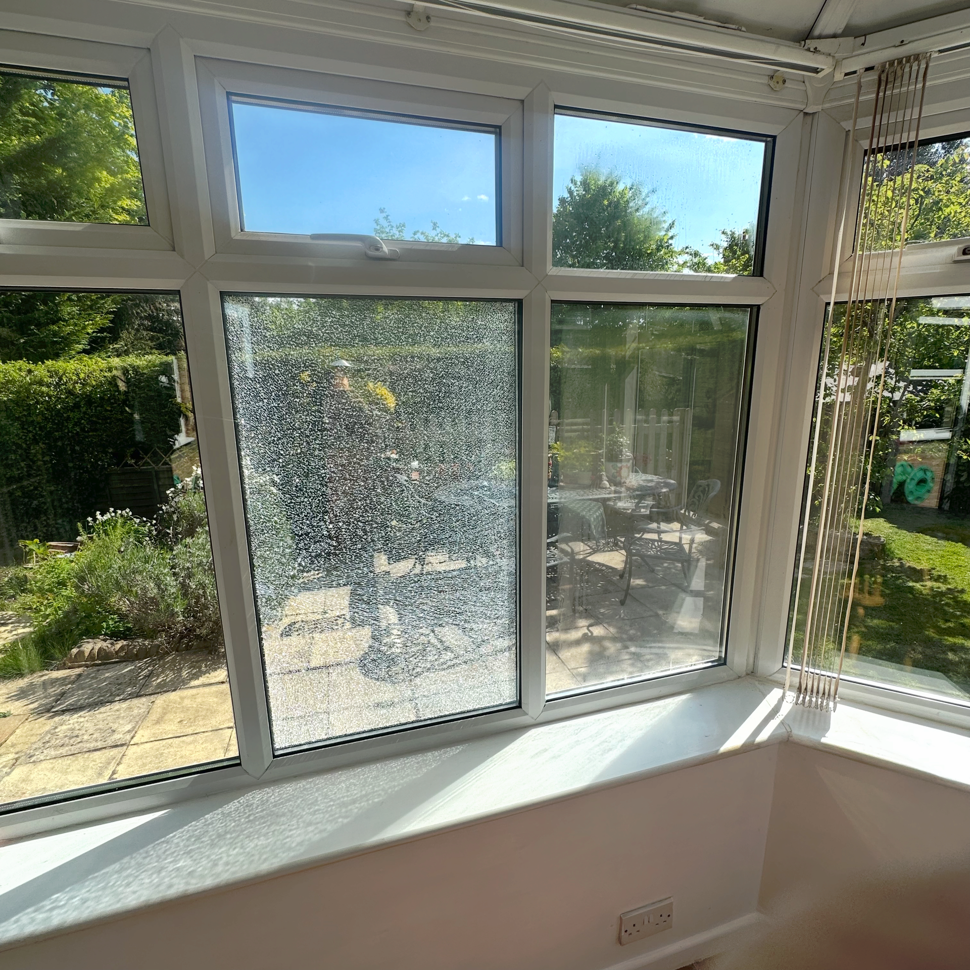A conservatory with a shattered double glazed unit. 