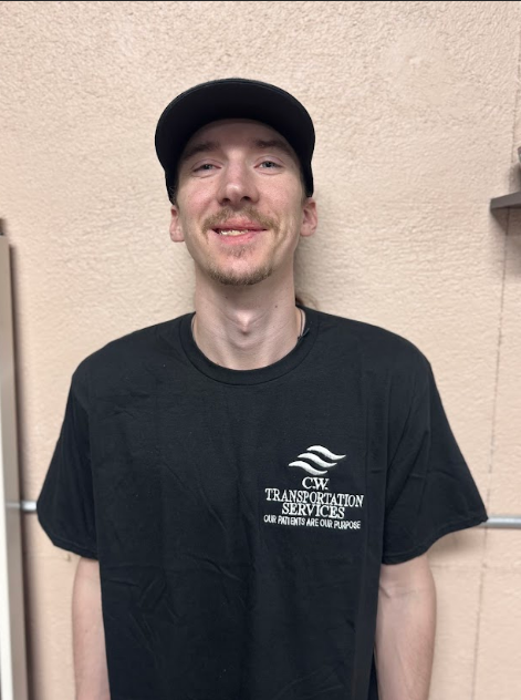A person wearing a black baseball cap and a black 