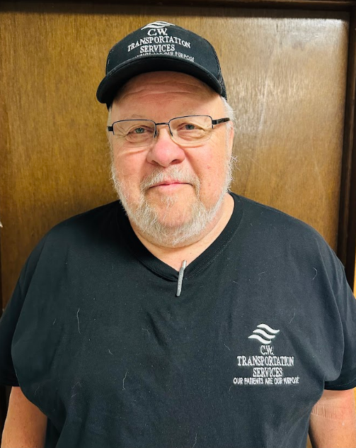 A person wearing a black t-shirt and baseball cap with matching 