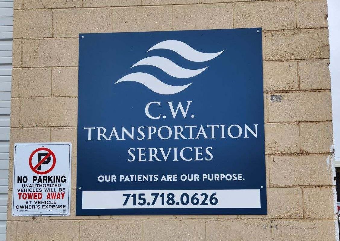 A sign for C.W. Transportation Services, with a phone number and the text 