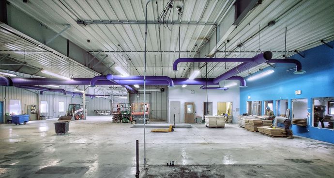 A large empty warehouse undergoing demolition.