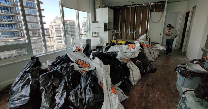 A condo undergoing demolition work with waste in bags.