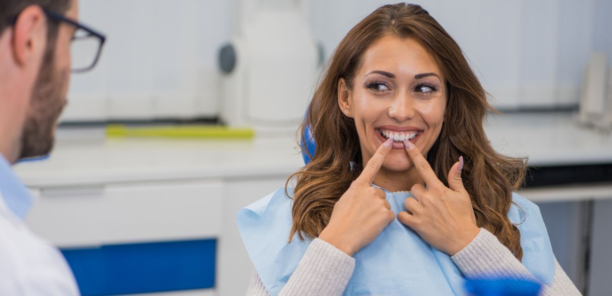 Dentist showing a smiling patient her teeth in a bright clinic