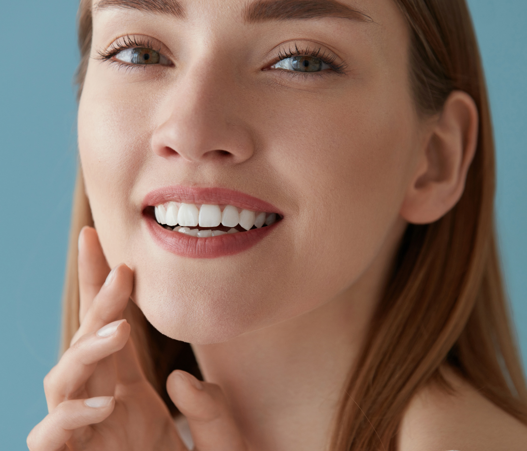 Close-up of a woman with flawless skin and a bright smile