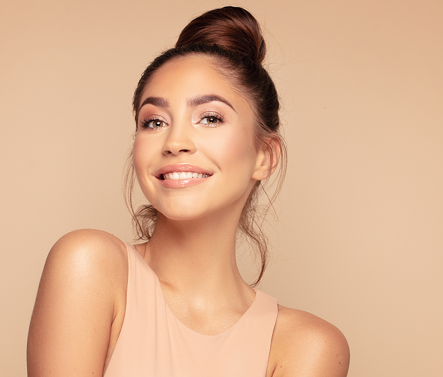 Woman with her hair in a bun smiling