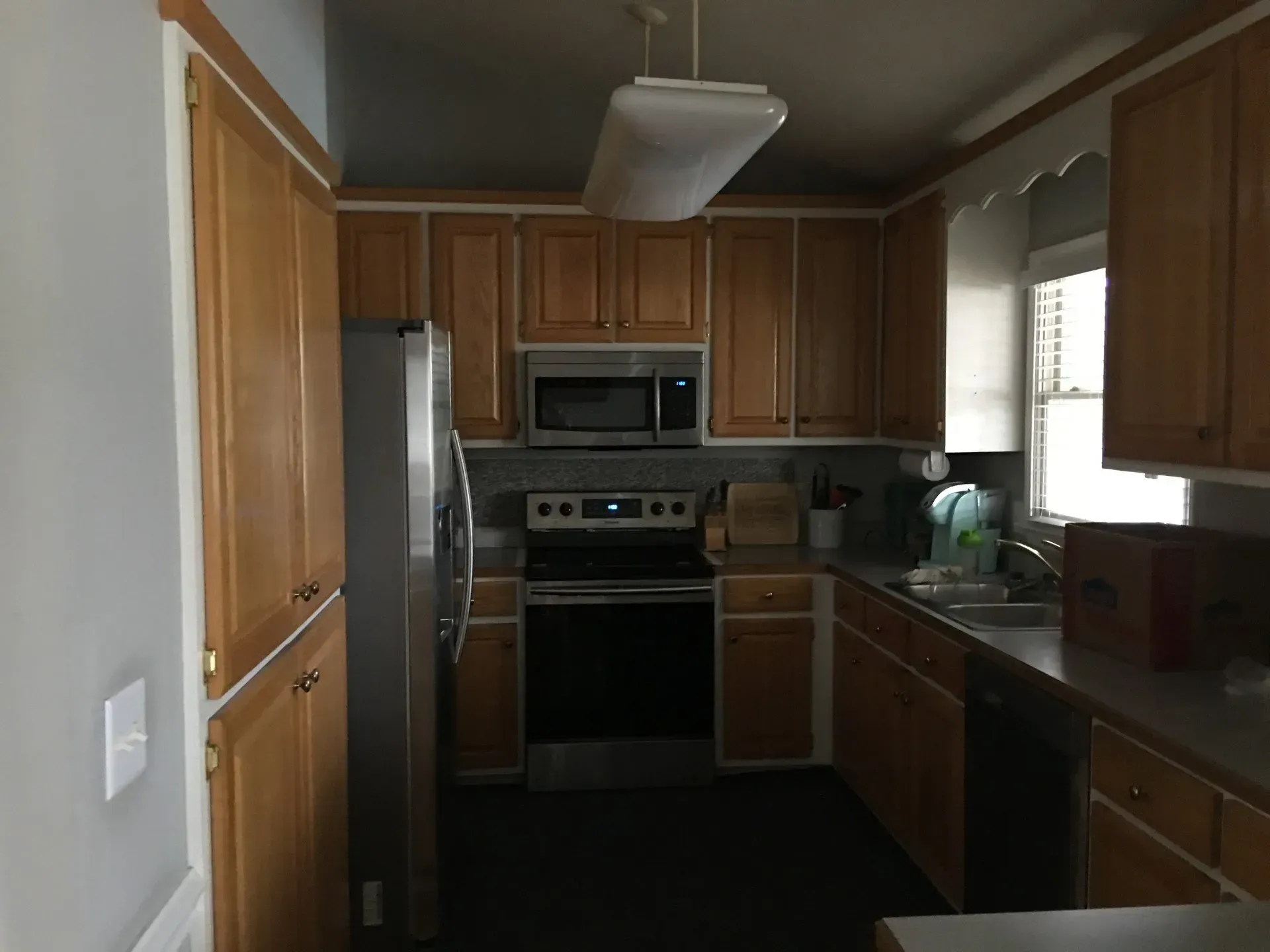 A kitchen with wooden cabinets and stainless steel appliances
