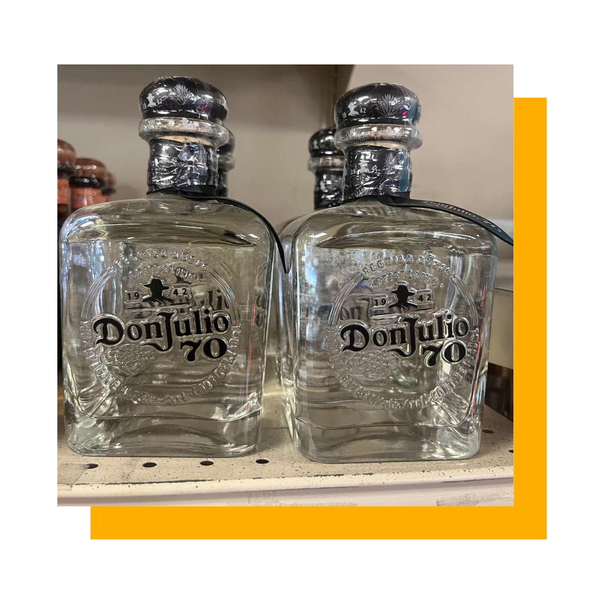 Two bottles of Don Julio 70 tequila on a store shelf, with a silver cap and black label.