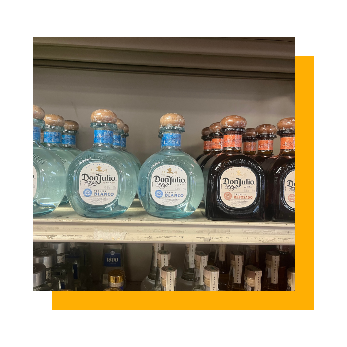 Bottles of Don Julio tequila on a shelf, in a store. Blue and black bottles.
