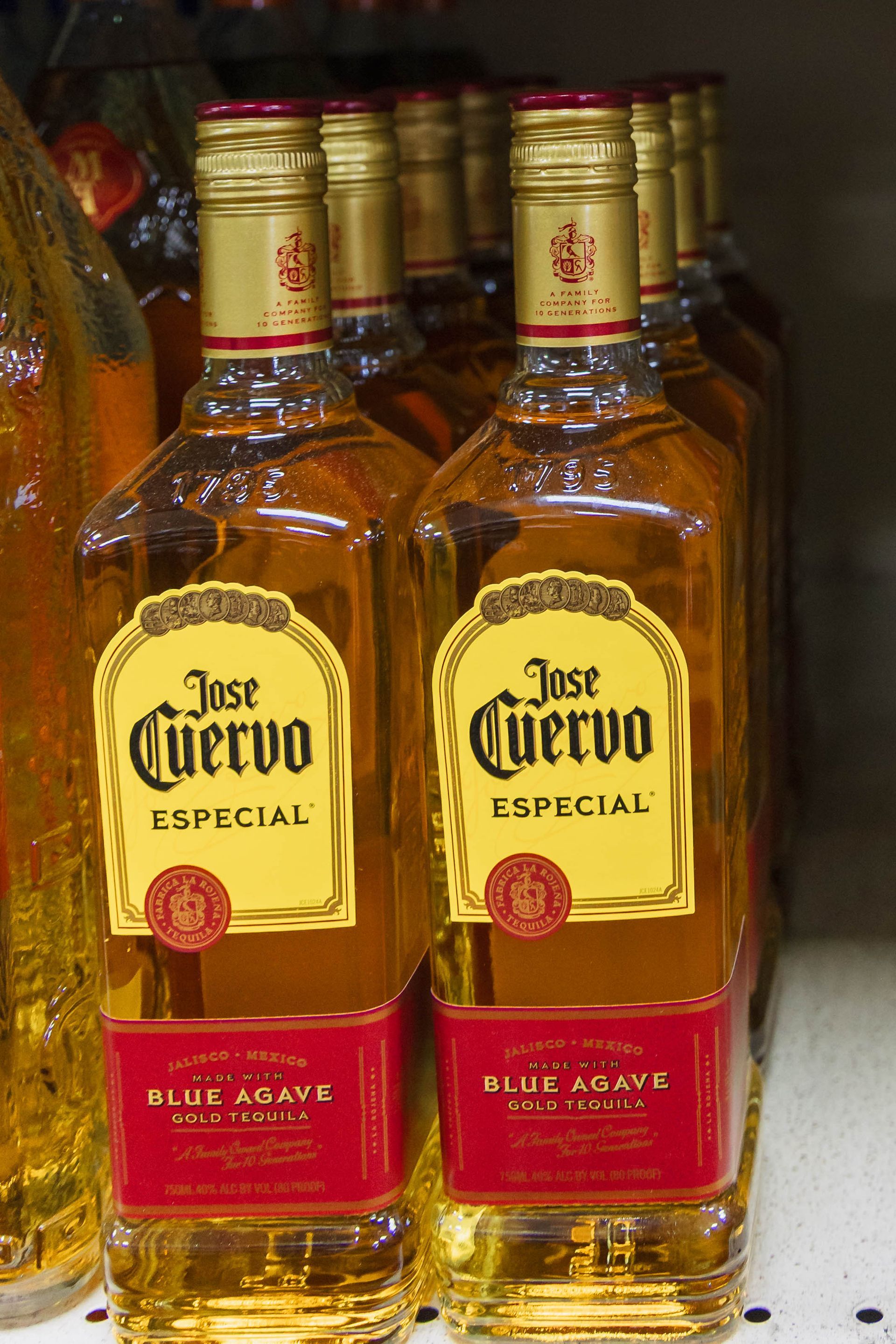 Bottles of Jose Cuervo Especial tequila on a store shelf.