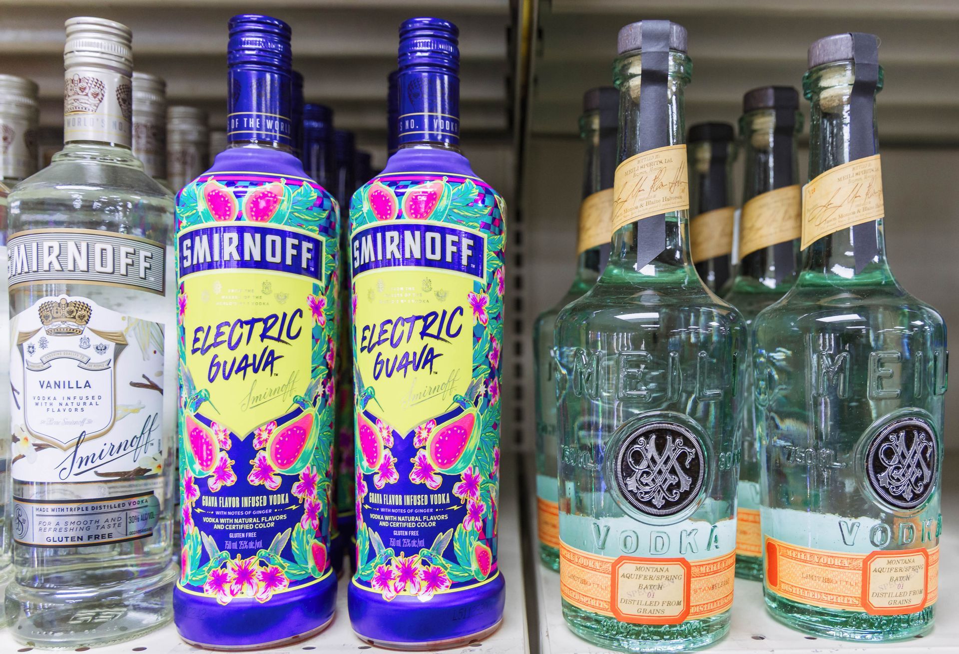 Bottles of Smirnoff vodka on a shelf, featuring the 