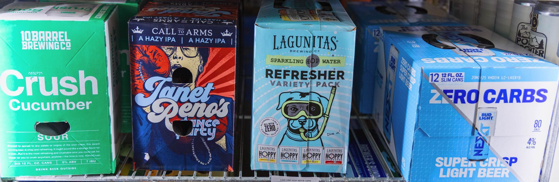 Four beverage boxes in a refrigerator: green 