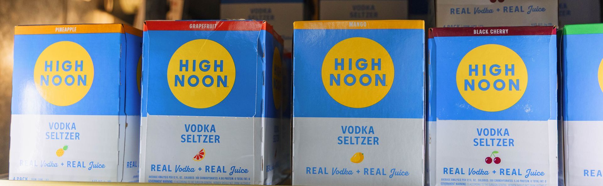 Boxes of High Noon Vodka Seltzer in various fruit flavors.