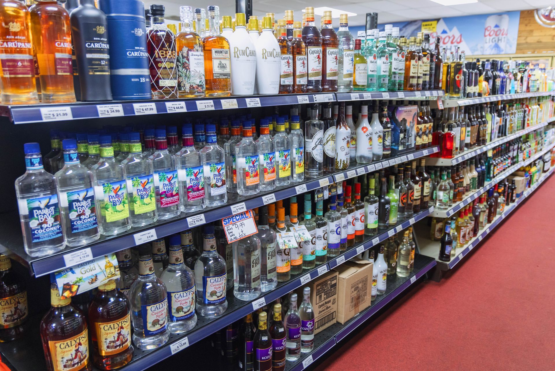 Shelves stocked with liquor bottles in a liquor store.