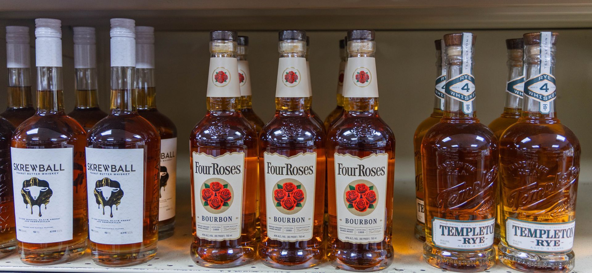 Bottles of liquor on a shelf, brands include 