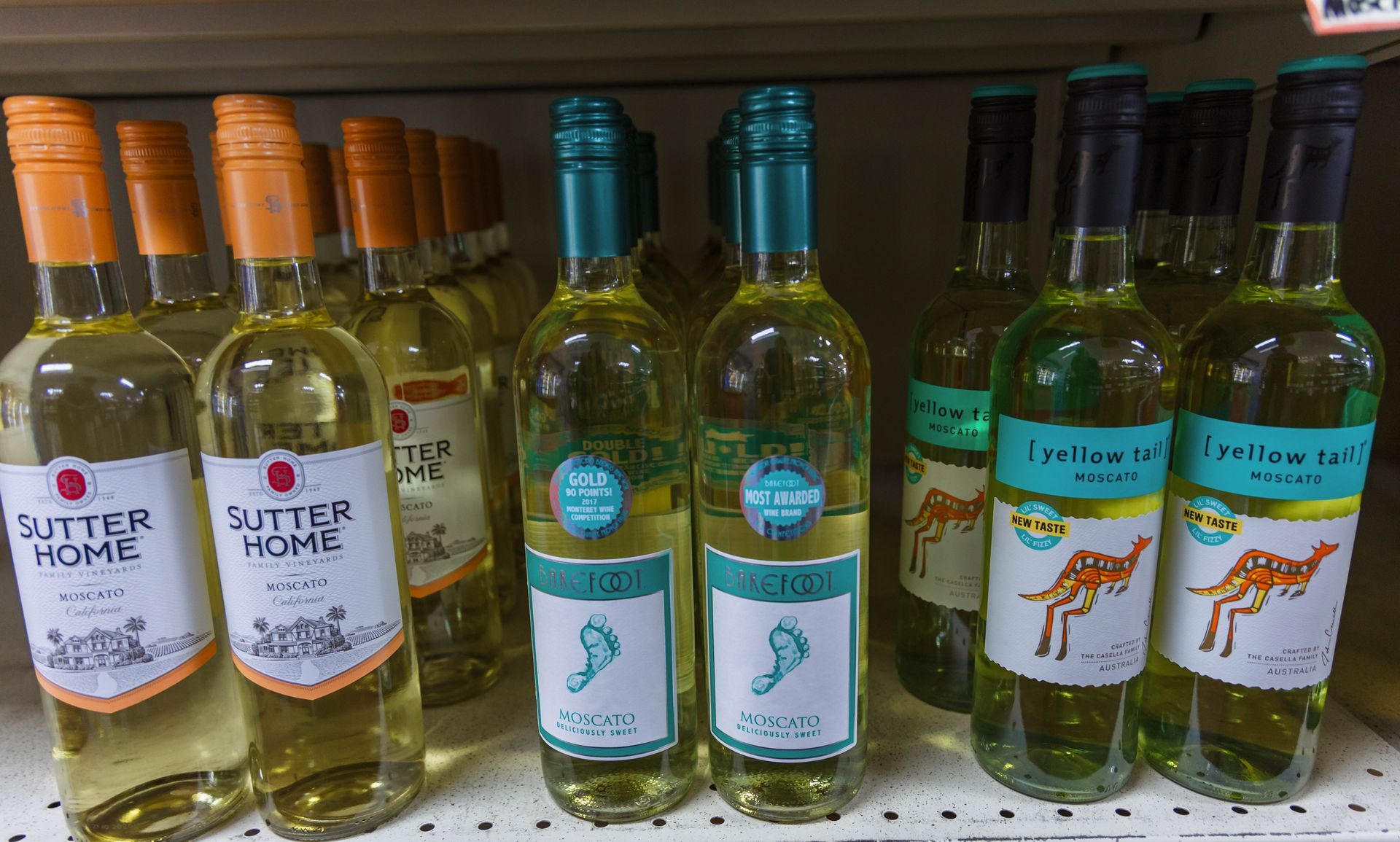 Wine bottles in a shelf with labels: 