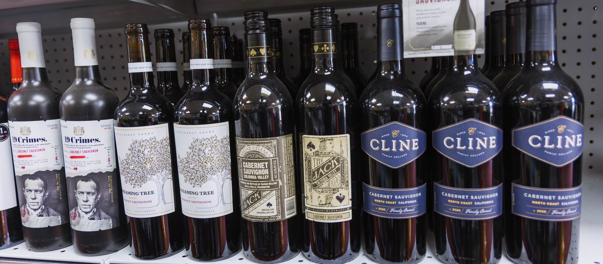 Wine bottles on a shelf, various labels, including 