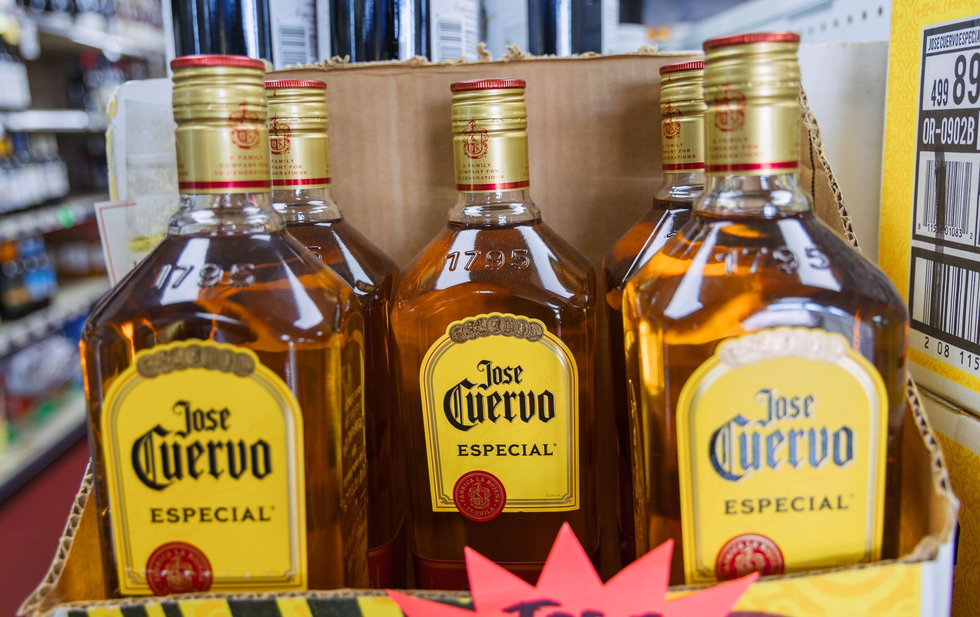 Jose Cuervo Especial tequila bottles in a cardboard display at a store.