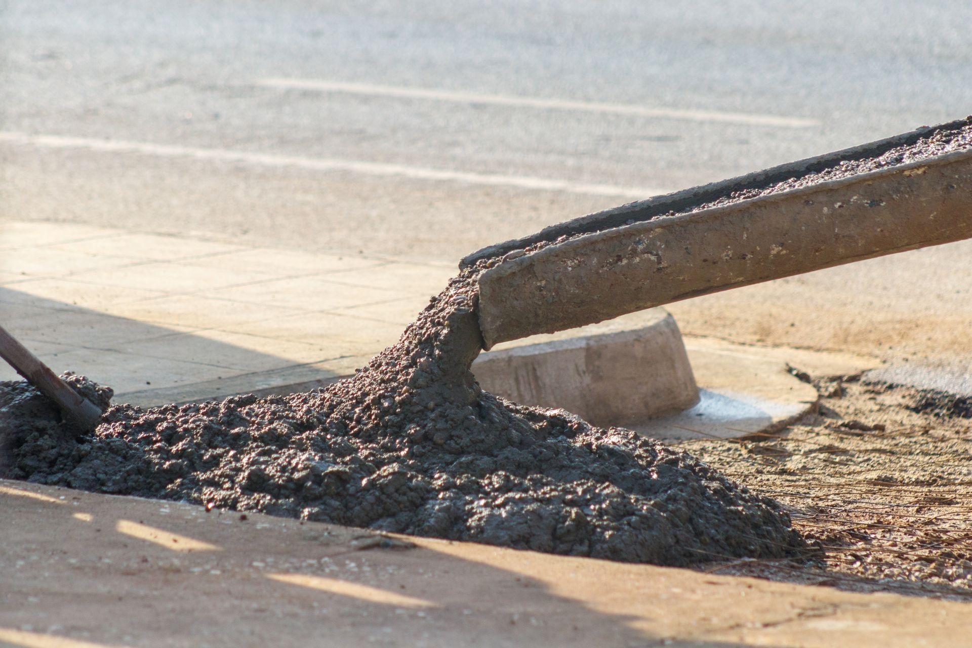 Concrete Service Contractor pouring fresh concrete mix for curb installation. Concrete Service Contractor pouring fresh concrete mix for curb installation.