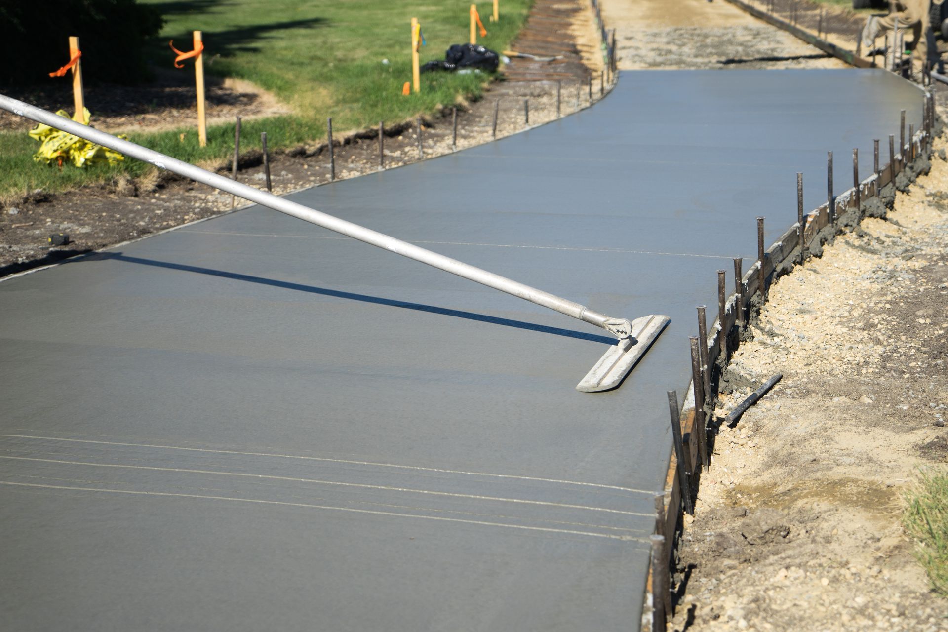 Newly poured concrete driveway showcasing professional work by a commercial concrete contractor.